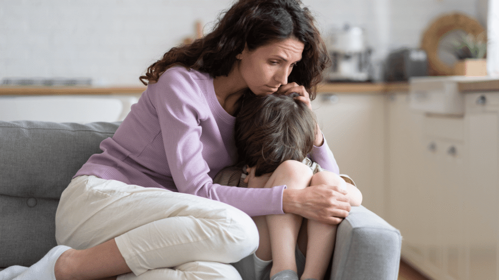 Mother hugging upset child