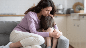 Mother hugging upset child